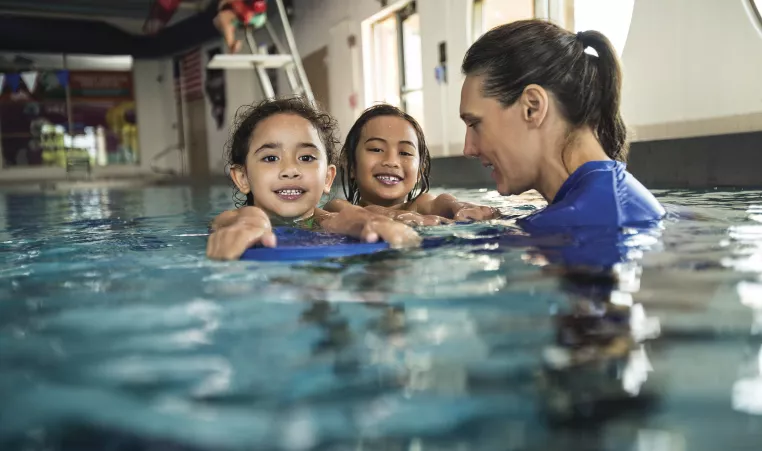 Child Swimming with instructor