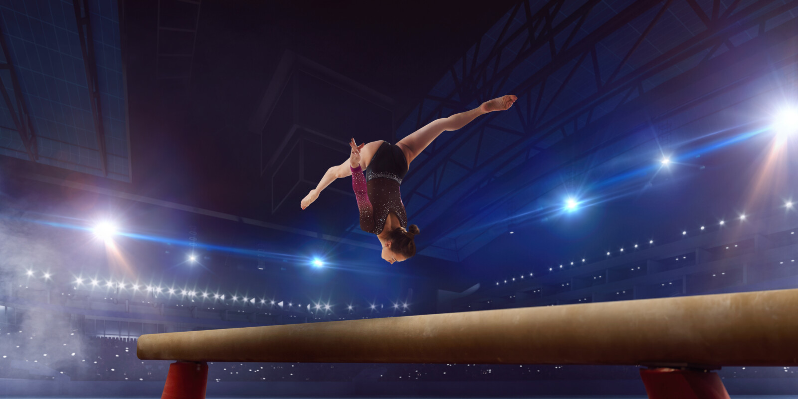 Female gymnast on professional arena.
